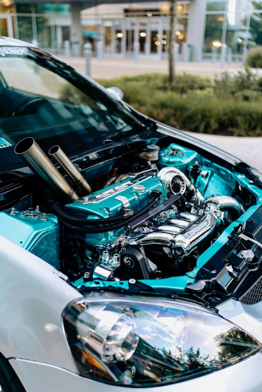 Detailed view of a contemporary car engine featuring a turbocharger, showcasing its sleek design.