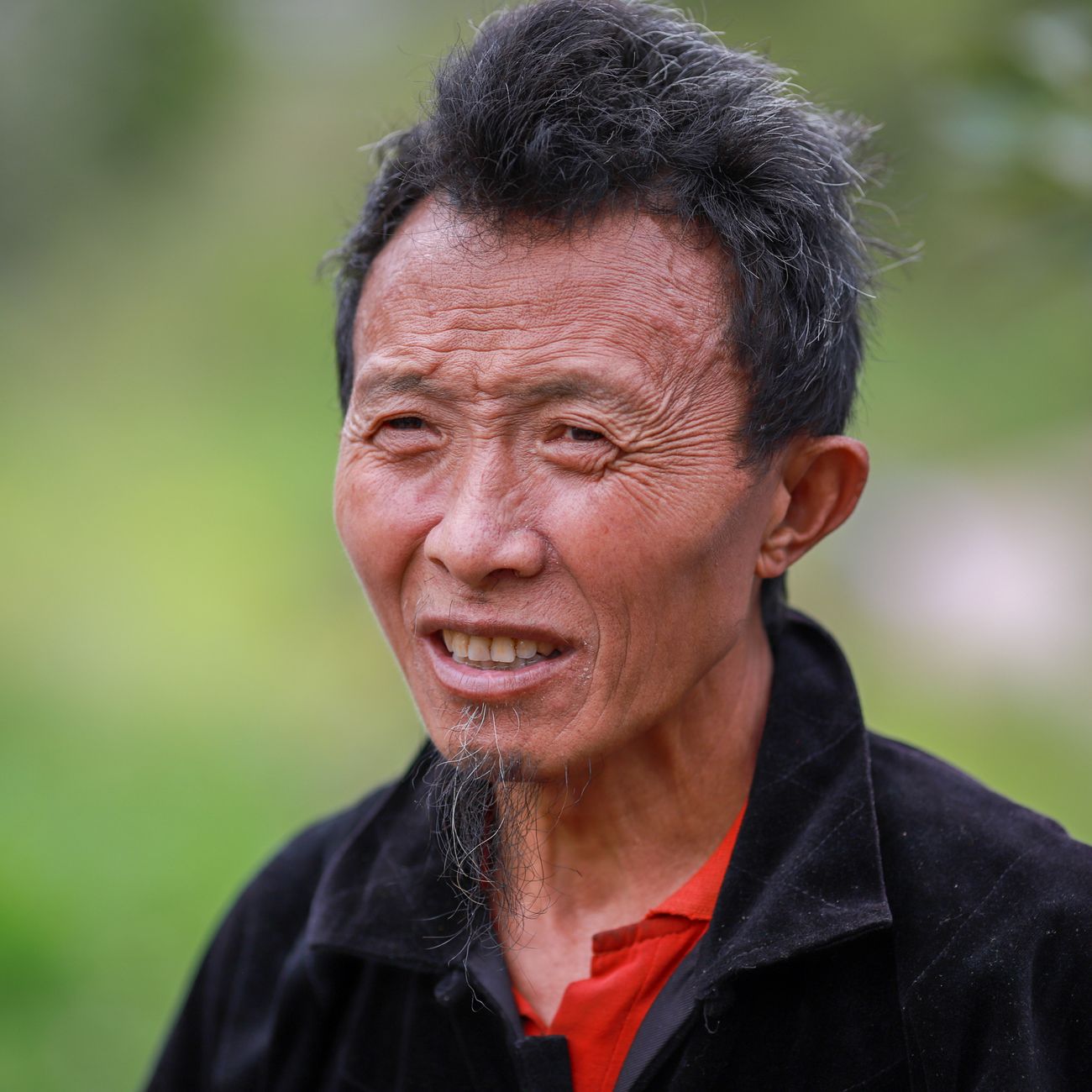 A smiling man in a headshot portrait