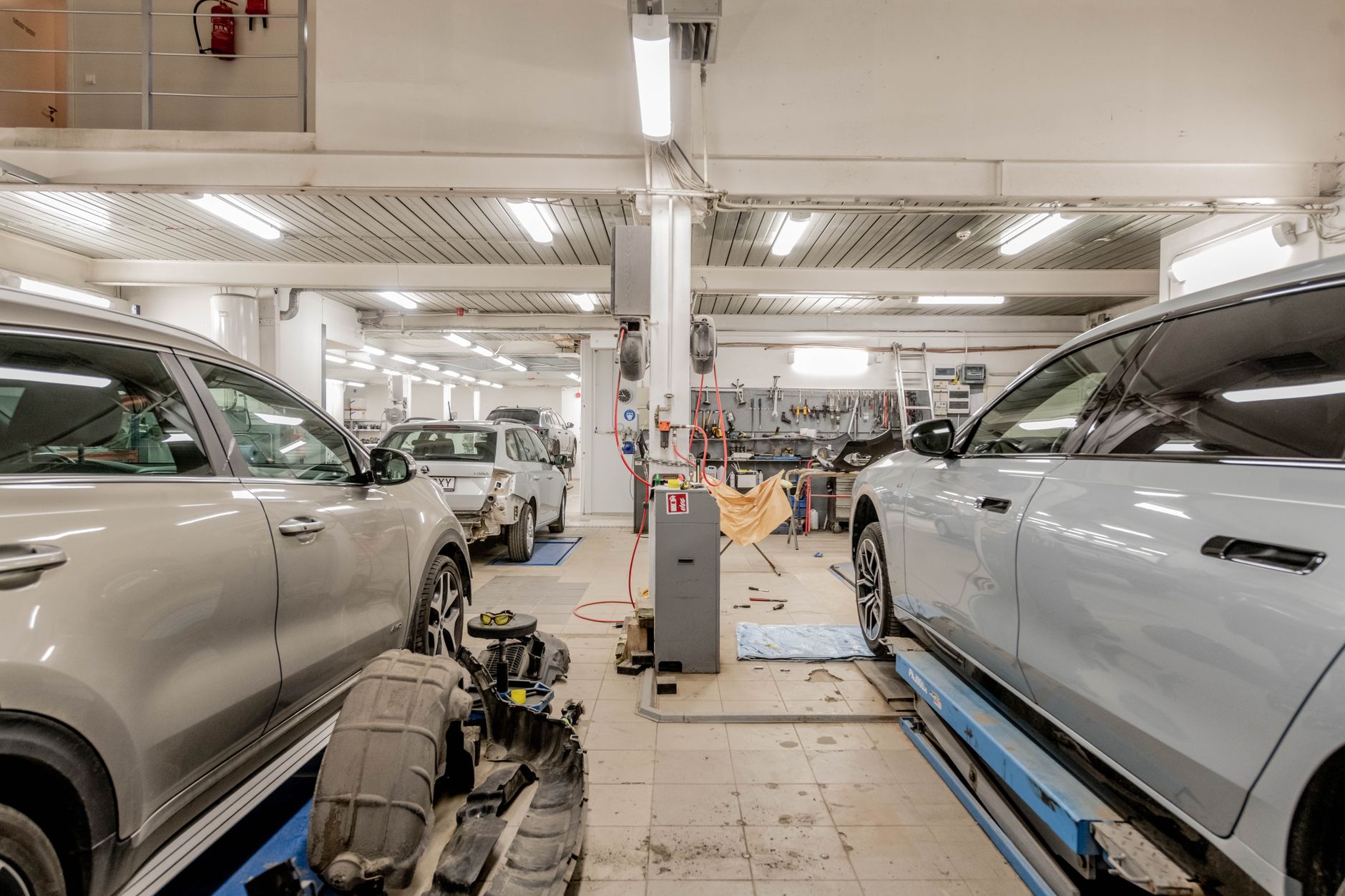 Photo of a repair shop interior with cars being serviced