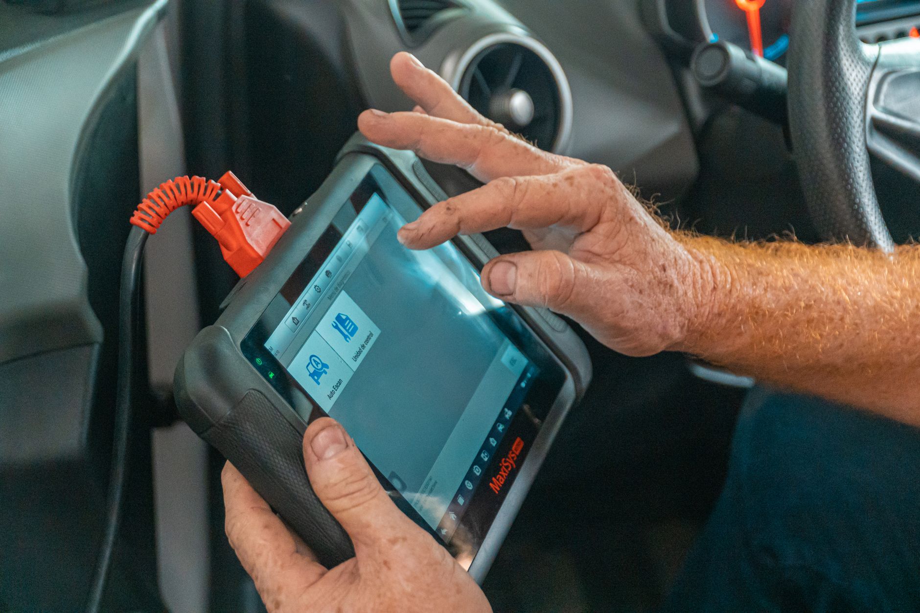 Photo of a mechanic reading engine diagnostics with a scan tool