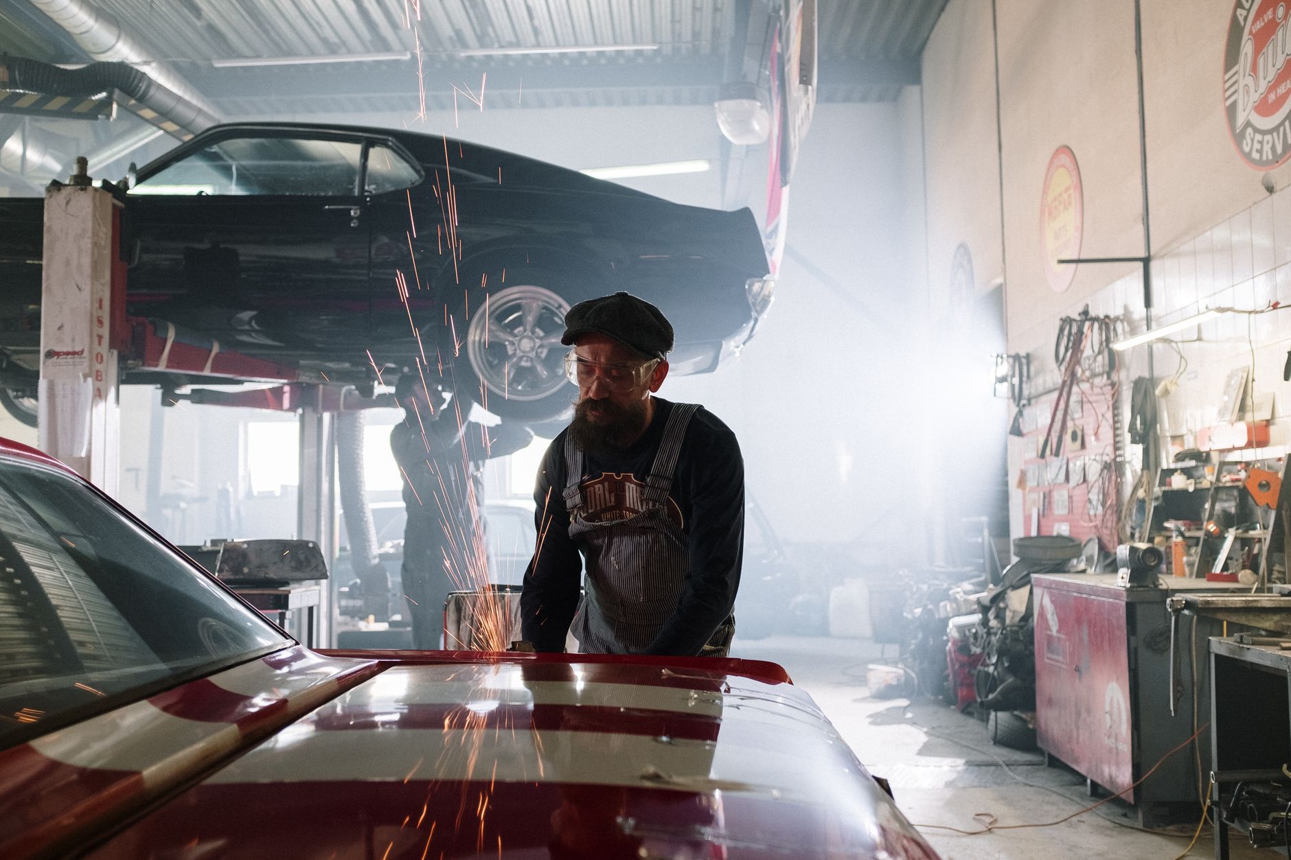 Photo of a mechanic repairing a car with sparks flying