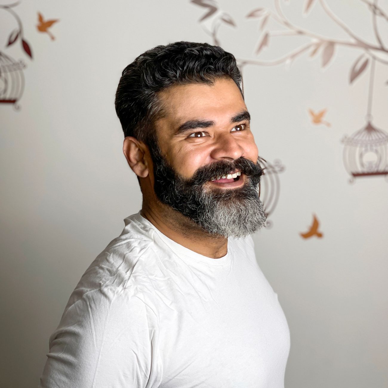 Portrait of a smiling bearded man indoors
