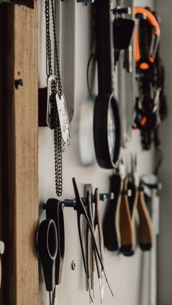 Tools hanging against an industrial-style workshop wall