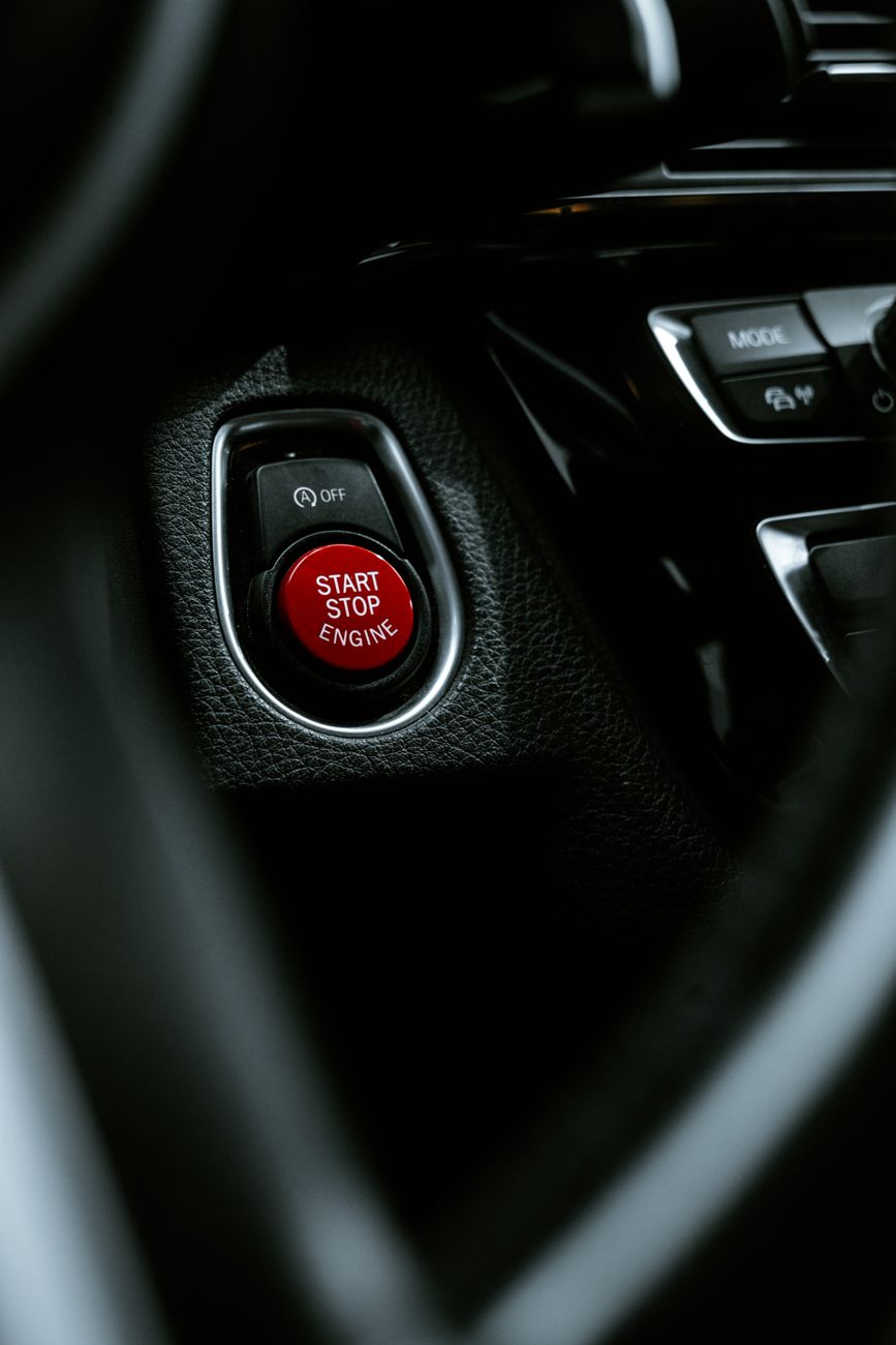 Start-stop button and controls in a car interior