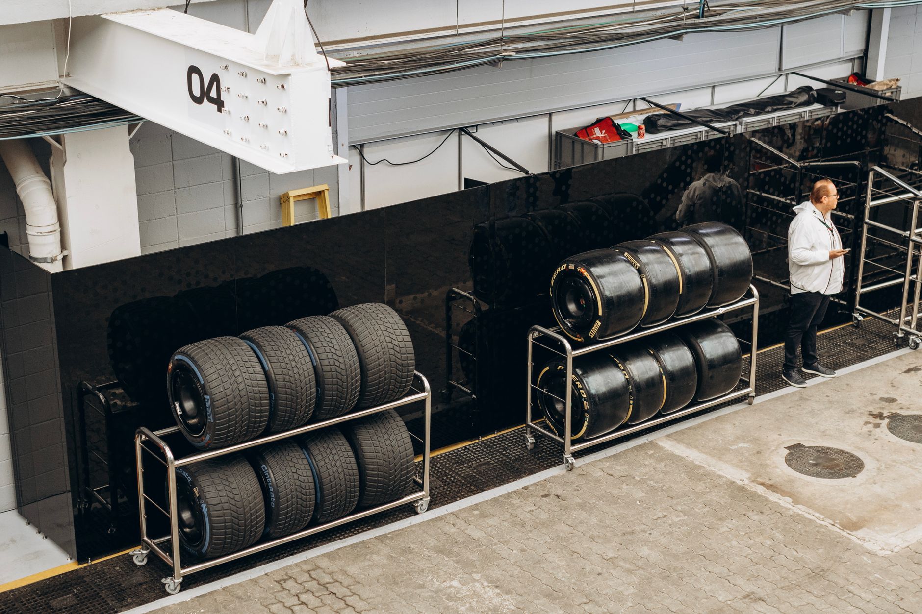 Stacked tires and wheel alignment equipment in the service bay
