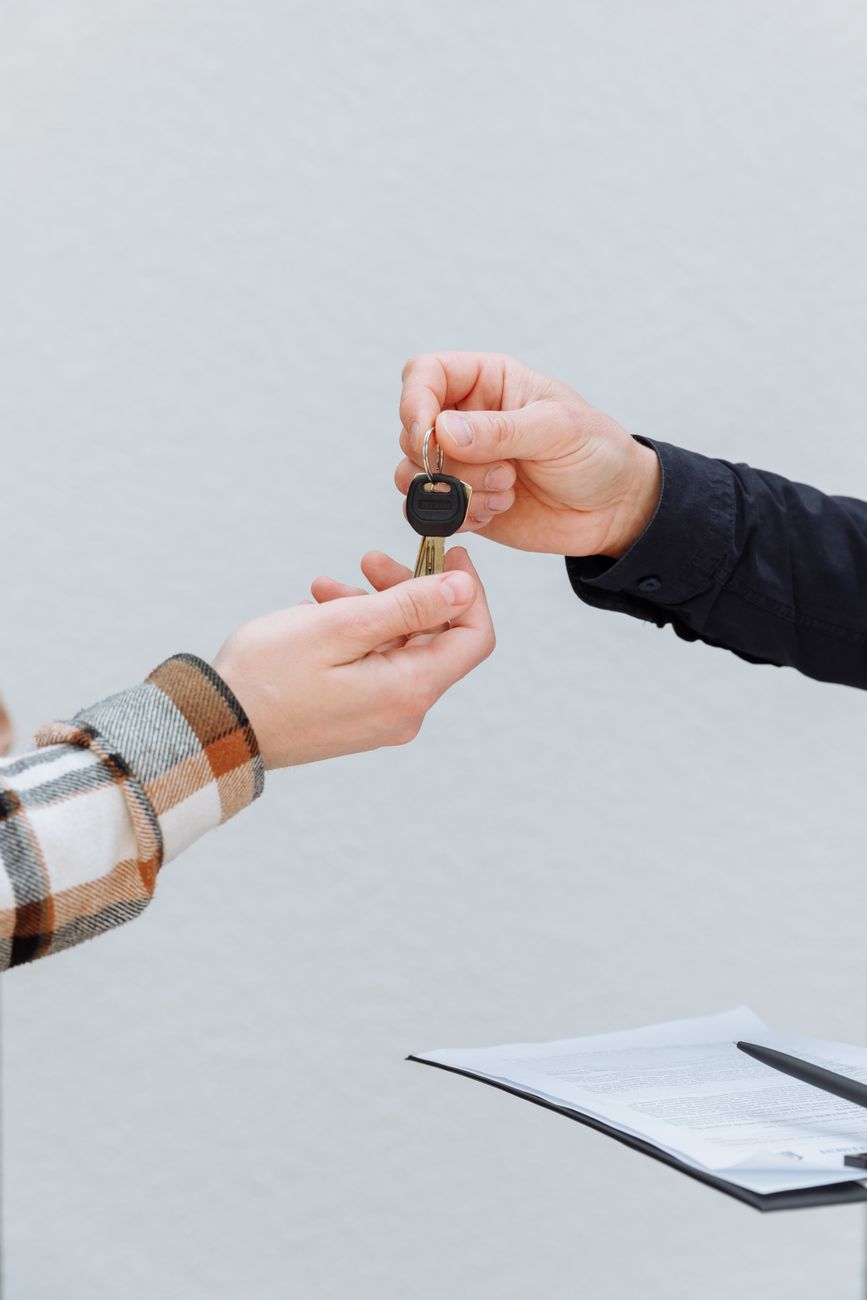Hands exchanging a car key
