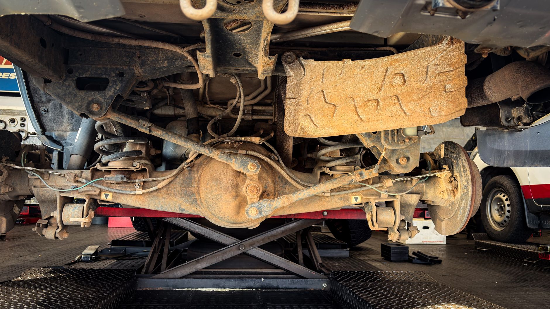 Before: Rusty suspension parts seen during a garage repair