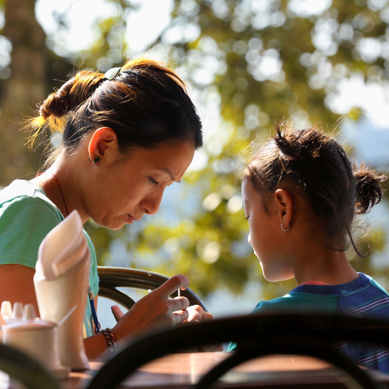 A preschool teacher talking with a parent