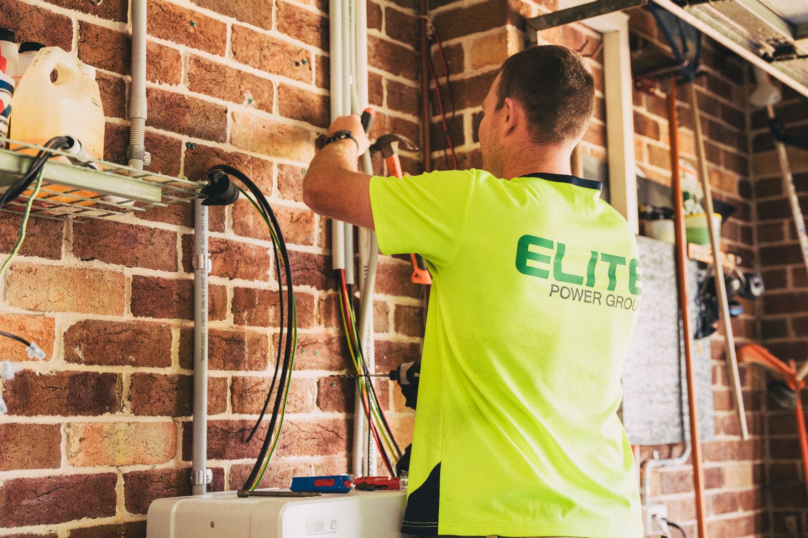 Electrician installing a home battery energy system