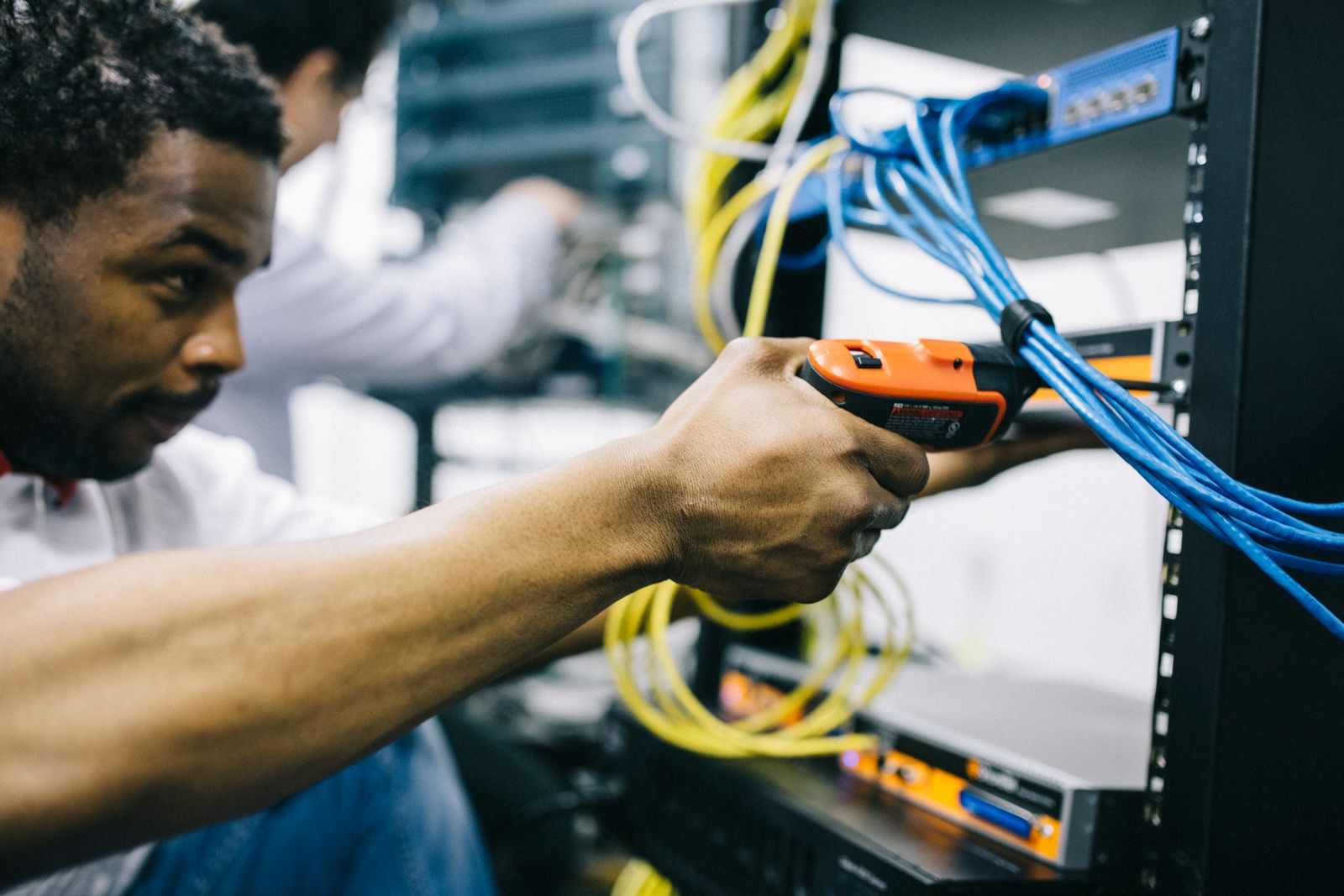 Technician working on a server rack and cabling
