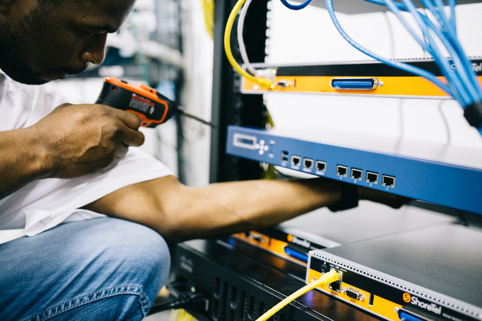 Electrical specialist configuring power distribution for server rack