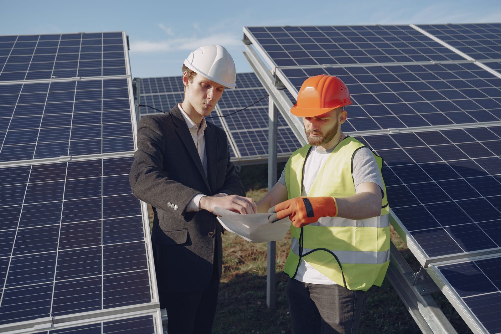 Renewable energy engineers surveying commercial solar installation